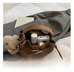 Interior view of brown pebble leather bucket bag showing capacity for phone and essentials