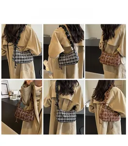 Detail view of stylish checkered underarm bags with bow accents and ruched shoulder straps
