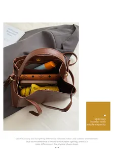 Top view of brown leather bucket bag interior holding a phone, umbrella, and wallet