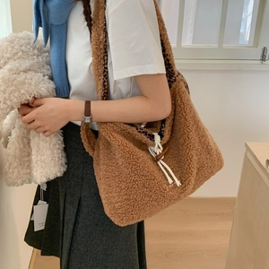 Detail of plush brown teddy fleece tote bag featuring leopard print lining and horn button