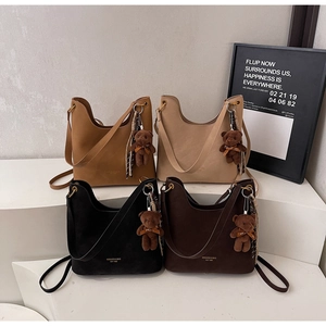 Detailed display of four suede tote bags in brown, beige, black, and coffee colors
