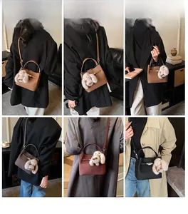 Detailed view of the vintage bucket bag in five colors with a plush rabbit charm accessory
