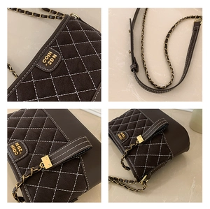 Detail of dark brown quilted crossbody bag featuring suede texture and gold chain strap