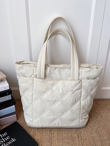 Chic beige quilted tote bag with diamond pattern and front pocket for daily commute