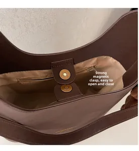 Detailed interior of dark brown hobo bag with magnetic closure and zipper pocket