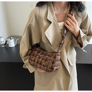 Detail of vintage brown plaid shoulder bag with bear patterns and scrunchie strap