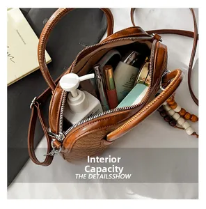 Detail of the brown textured handbag interior showing capacity for cosmetics and essentials