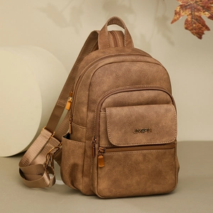 Macro detail of dark brown retro leather backpack with dual zippers and JINGPIN logo