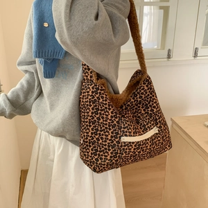 Macro detail of plush leopard print crossbody bag with functional white zipper pocket