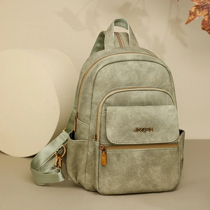 Detail of green PU leather multi-purpose backpack with gold JINGPIN logo and zippers
