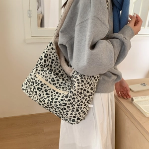Detail of plush tote bag with black and white leopard print and warm fleece lining