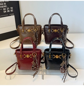 Detail view of retro leather bucket bags with heart gold buckles in multiple colors