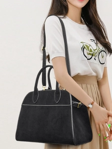 Minimalist black matte tote bag with contrast stitching and adjustable shoulder strap