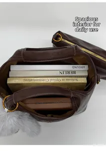 Top view of large capacity dark brown tote bag with books inside and inner pouch