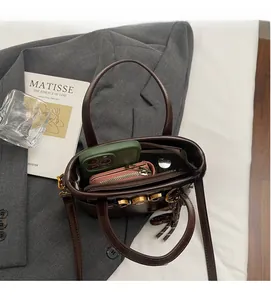 Detailed interior view showing large capacity for phone and wallet in dark brown bucket bag