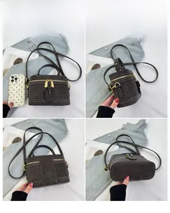 Mehrwinkel-Ansichten einer Vintage dunkelbraunen Krokodil-Muster Tasche mit Gold-Zippern