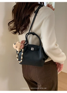 Black lychee texture bucket bag with cute plush bear charm and silver hardware detail