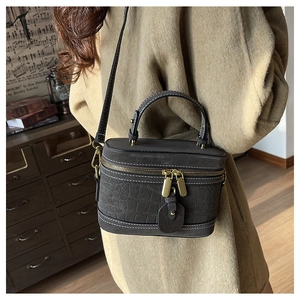 Detail of grey crocodile texture PU leather bucket bag with vintage bronze hardware
