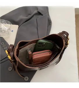 Top view of deep brown leather bucket bag interior showing spacious capacity and pockets