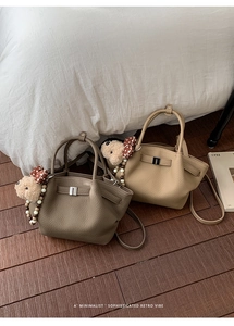 Detail of lychee pattern leather handbags with metal buckles and cute bear charms