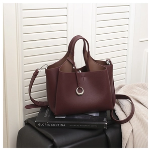 Deep red lychee texture bucket bag with dual handles and detachable shoulder strap