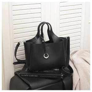 Detail of black lychee grain leather bucket bag with silver ring and T-logo embossing