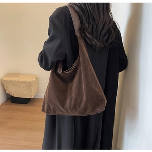 Detailed view of deep brown suede tote bag with soft texture and minimalist aesthetic