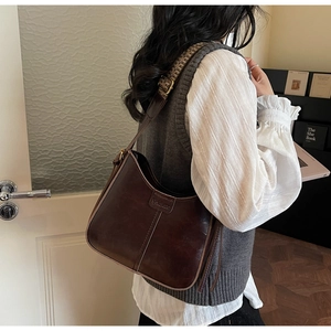 Detail of dark brown vintage hobo bag with a stylish wide leopard print shoulder strap