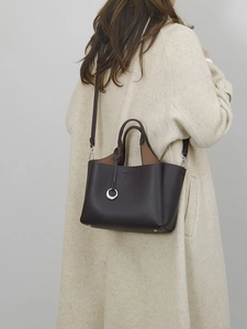 Deep brown lychee pattern leather bucket bag with T-logo and adjustable strap