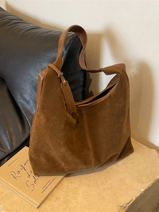 Brown velvet tote bag with leather straps in a minimalist vintage French style