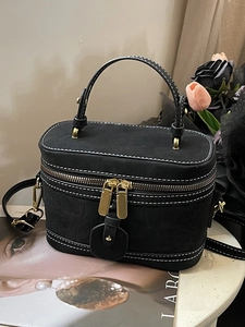 Elegant black bucket bag with crocodile texture, contrast stitching and gold metal hardware