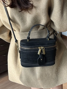 Retro black bucket bag with crocodile embossing and white contrast stitching detail