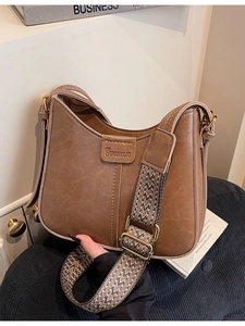 Retro brown bucket bag with textured faux leather and colorful woven wide shoulder strap