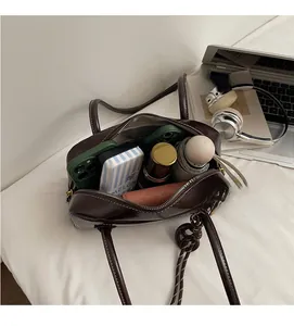 Vue macro de l'intérieur spacieux du sac en cuir marron avec objets du quotidien