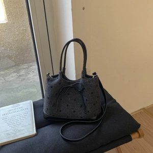 Detailed view of the polka dot tote bag texture and elegant leather bow attachment
