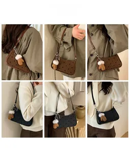 Polka dot underarm bag in brown and grey with plush glove pendant accessory