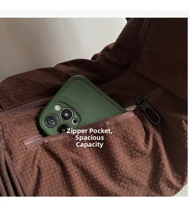 Close-up of the rear zipper pocket on a brown checkered bag showing large phone capacity