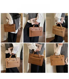 Borsa porta pc marrone in pelle con tasca frontale vintage indossata da una modella