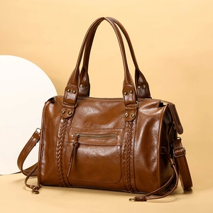 Dettagli della borsa tote vintage marrone con inserti intrecciati e metallo bronzo