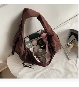 Detailed interior of dark brown textured bag showing large capacity and zipper closure