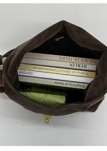 Top view of retro dark brown tote bag interior showing capacity for books and an umbrella