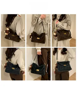 Detail view of vintage crossbody tote bags in brown and navy with metal buckles