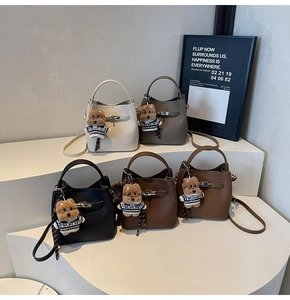 Macro detail of bucket bags in five colors with leather texture and bear charms
