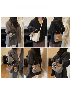 Multiple colors of minimalist bucket bags shown in use with cute bear pendant