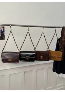Détail de quatre sacs à bandoulière colorés avec boucles magnétiques en diverses finitions