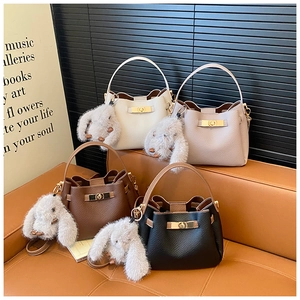 Litchi pattern bucket bags with gold twist locks and plush bunny charms in four colors