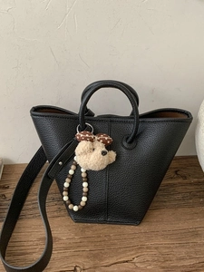 Chic black litchi leather bucket tote bag with cute bear charm and cross-body strap