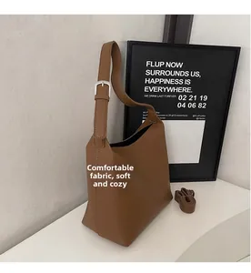 Detailed view of brown pebbled leather texture with adjustable strap and soft finish