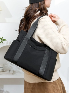 Minimalist black nylon tote bag for women with large capacity and woven shoulder strap