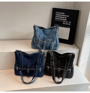 Detailed view of vintage washed denim tote bags in light blue, dark blue and charcoal black